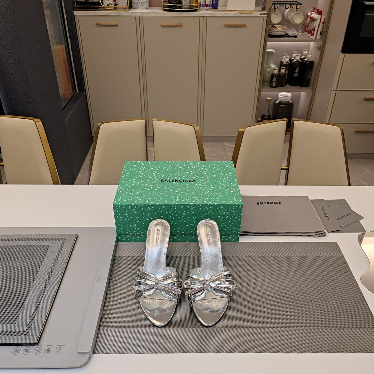 BOW-EMBELLISHED HIGH MULES IN SILVER METALLIC SHEEPSKIN